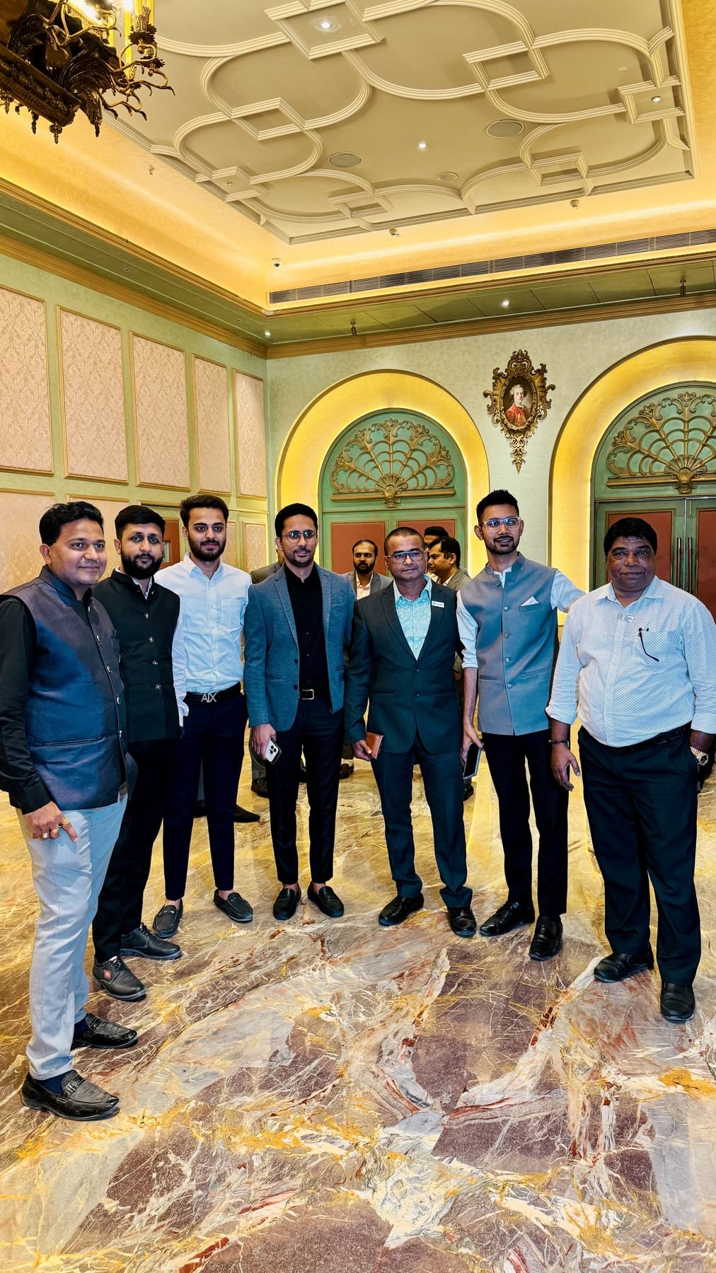 With the wider team at a formal gathering